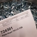 Box full of Ojop latch components with products label on top